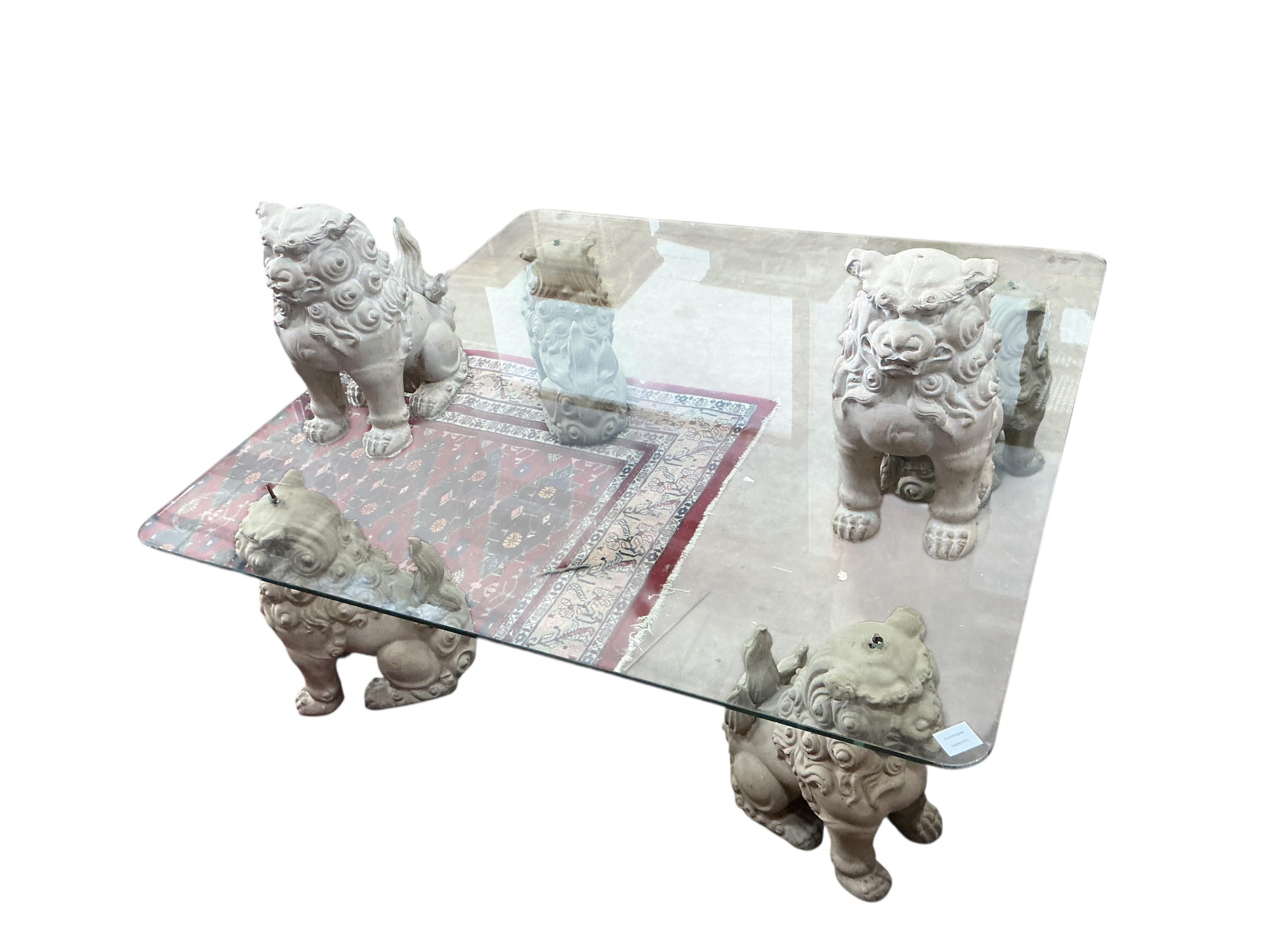 A square glass coffee table with composition shi-shi supports, 122cm, height 39cm